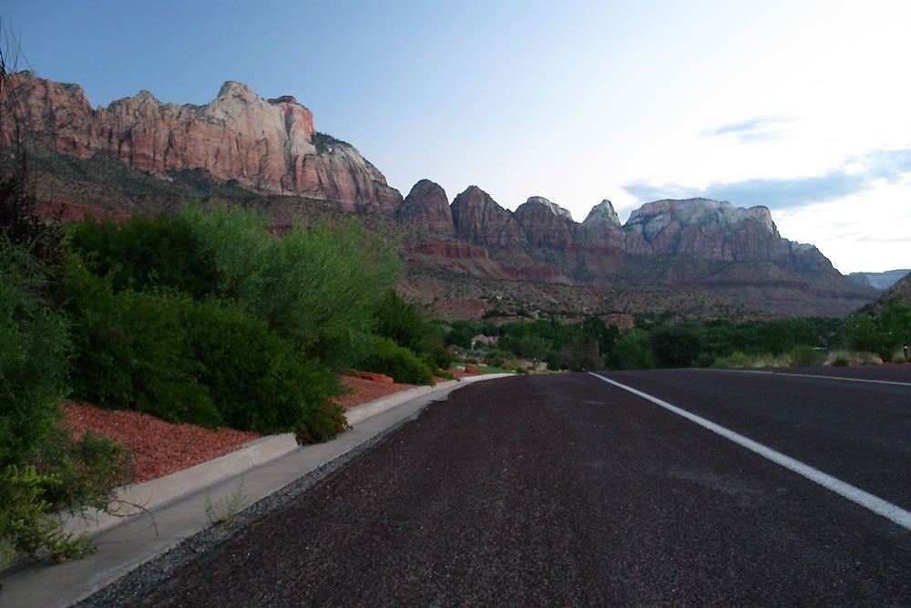 Breathtaking view of red mountains along a coastal road.