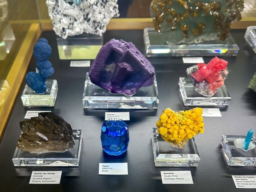 A vibrant array of minerals and gems showcased on clear bases, highlighting their unique colors and formations.