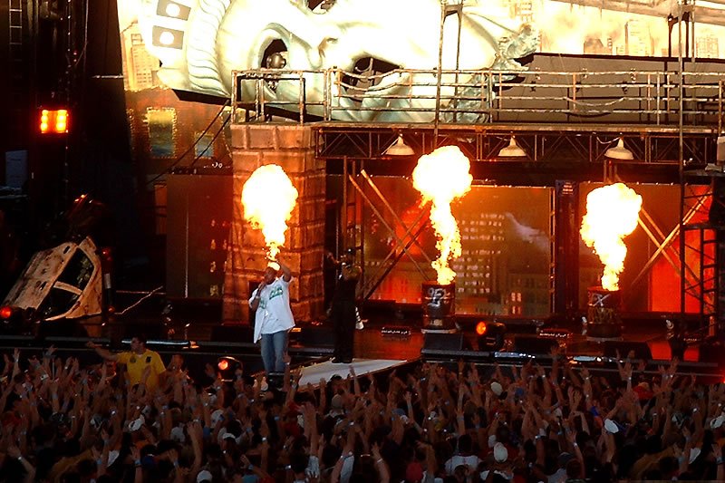 John and Kristie at a live concert with fire displays on stage