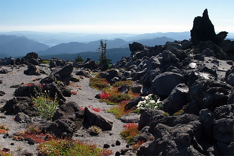 View on top of the Continental Divide from a rocky ridge with scenic mountains and valleys in the background