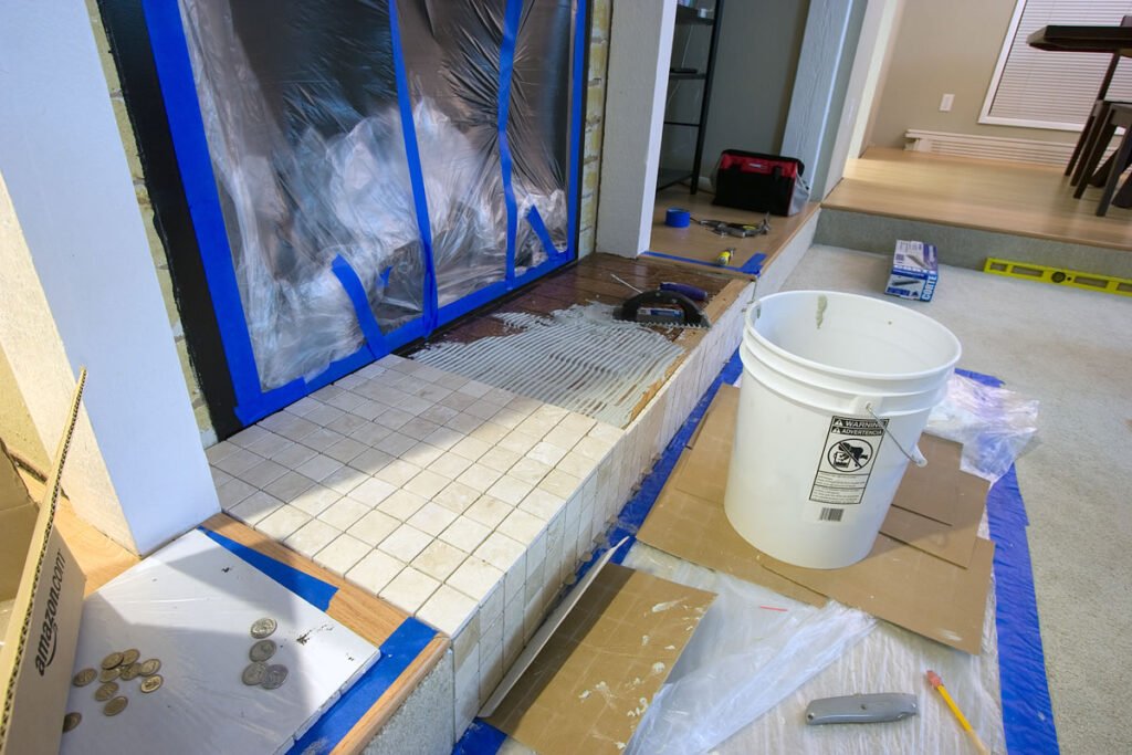Electrical components and circular mechanism parts on a pinkish surface. Part of a homemade air hockey table build.