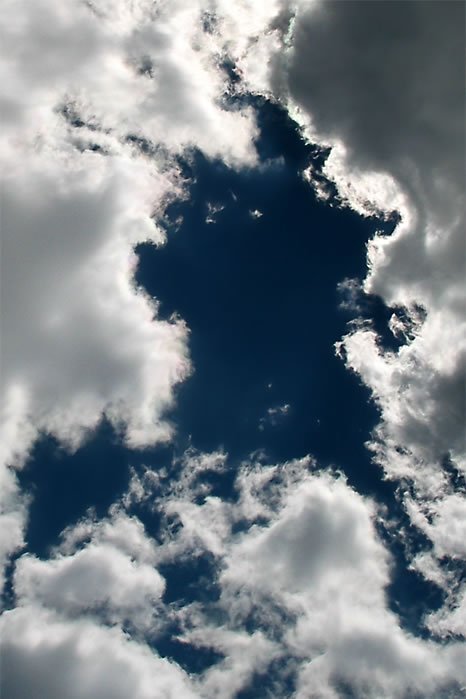 A striking image of fluffy white clouds against a deep blue sky. The clouds create dynamic patterns, highlighting nature's beauty.
