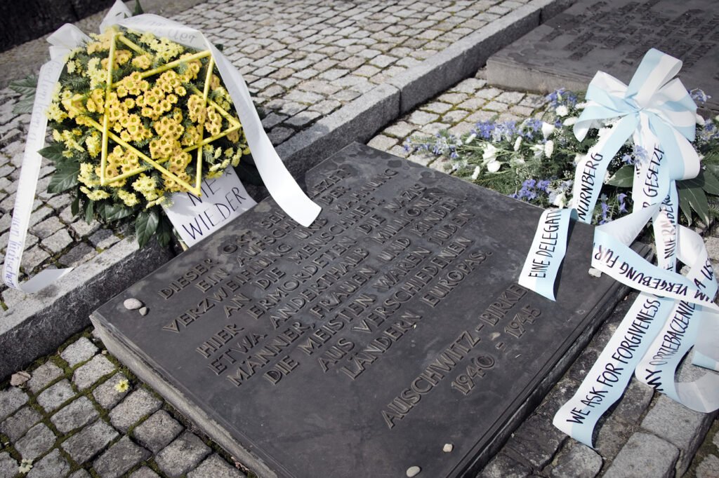 A detailed image showcasing the grave of Fresno Joice, adorned with vibrant yellow flowers and white ribbons alongside a poignant note of remembrance.