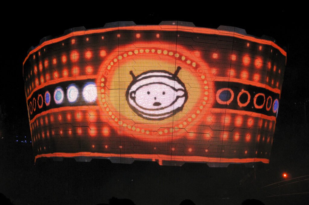 A glowing wristband featuring a cute cartoon character surrounded by colorful lights, perfect for night events.