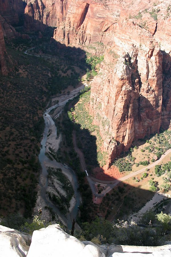A breathtaking view of the Grand Canyon with a winding river and rugged red rock walls.