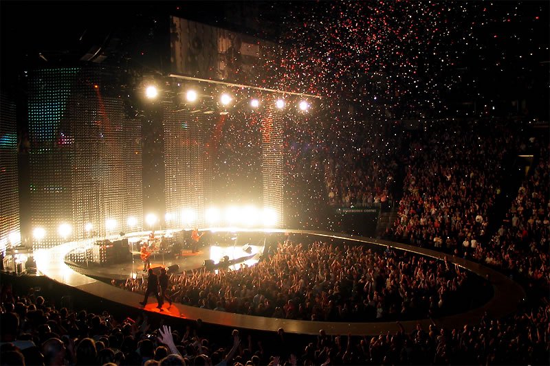 Open photo album page displaying concert images and a smiling couple portrait.