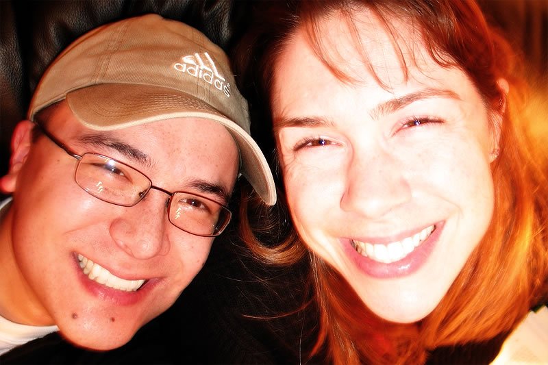 A close-up of John and Kristie smiling indoors, capturing their joyful expressions.