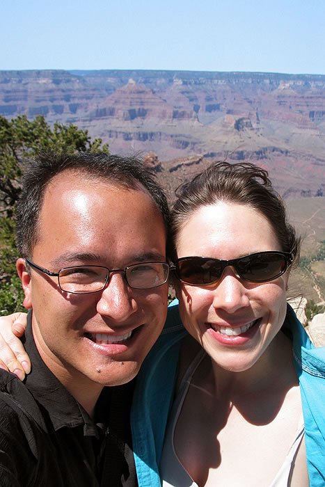 John and Kristie smile for a selfie with the Grand Canyon in the background.