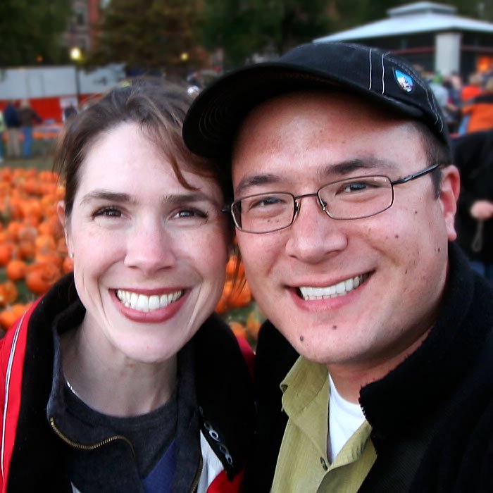 John and Kristie share a joyful moment at a pumpkin patch, capturing their love and the season’s charm.