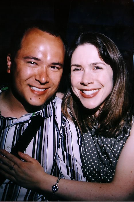 A close-up image of John and Kristie smiling warmly at the camera. They appear happy and affectionate.