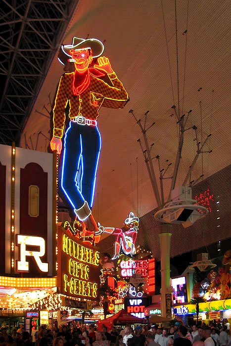 The famous neon cowboy at MSG Sphere in Las Vegas under night sky.
