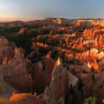 A breathtaking view of a towering rock formation under a clear sky.