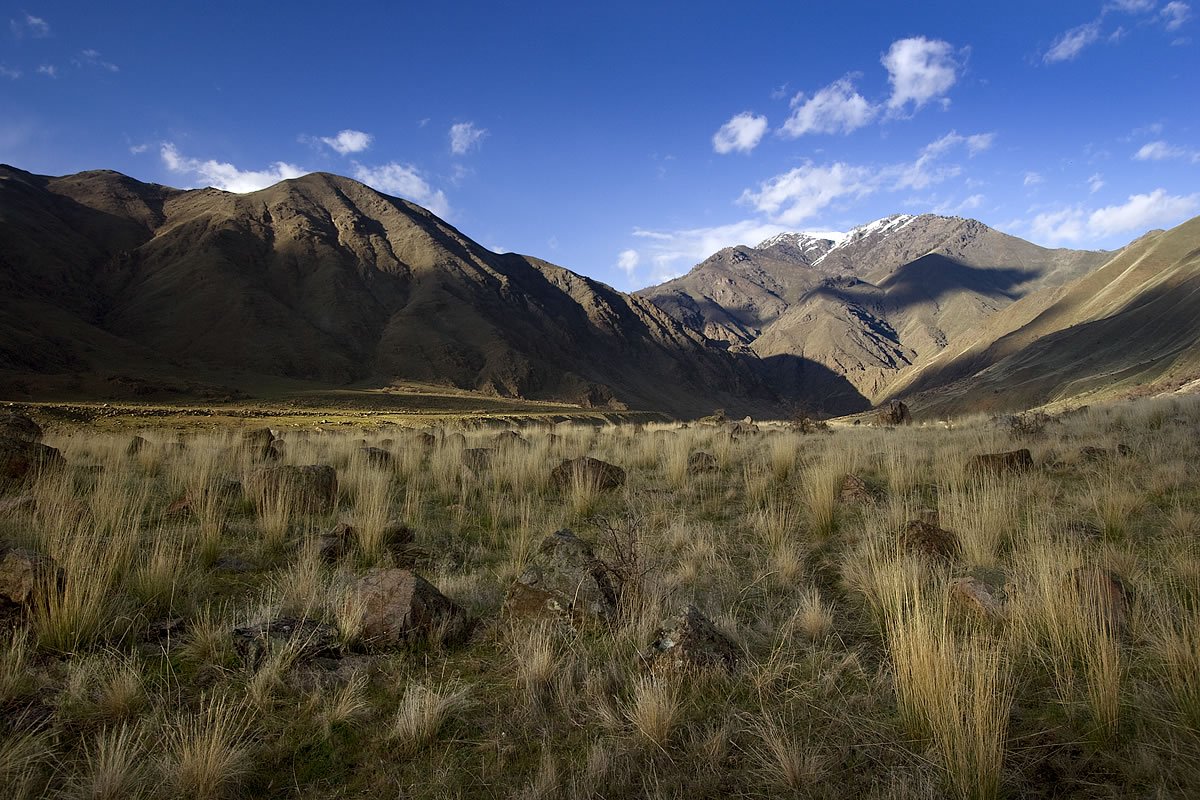 The Snake River Trail A stunning view of a mountain range with rugged peaks under a clear blue sky.