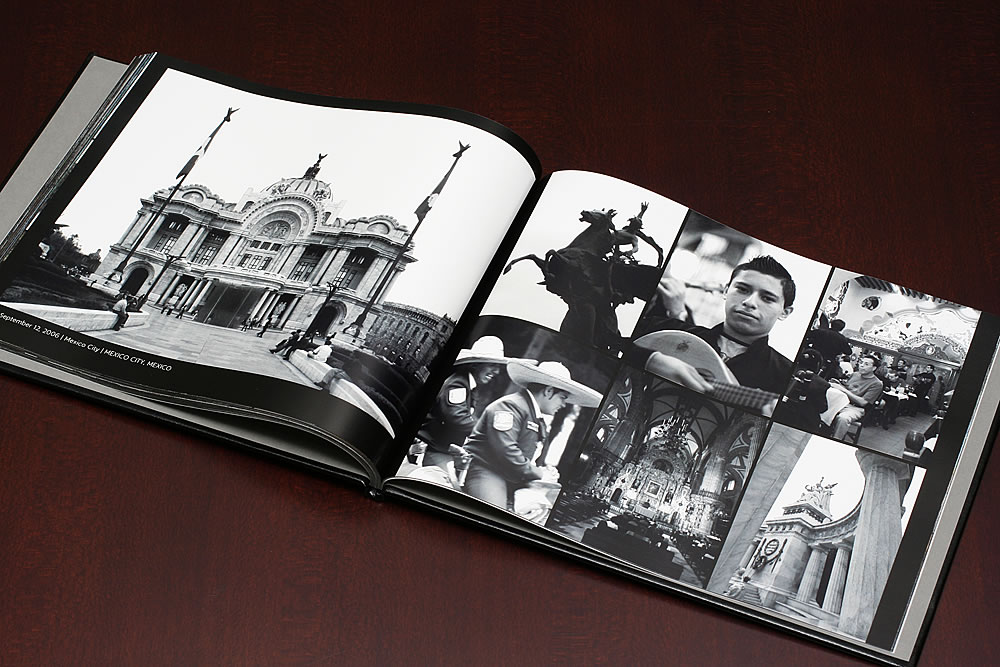 An open black and white photo book displays various images. Details include both large full-page photographs and smaller arranged photos.