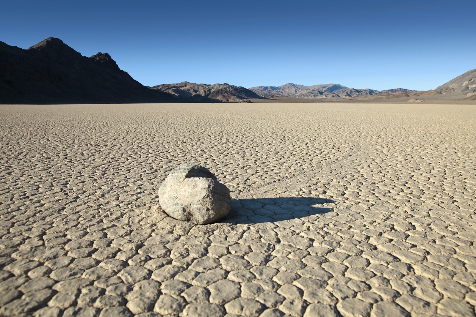 The Racetrack A lone sailing stone rests on the cracked mudflats of Racetrack Playa in Death Valley National Park. Photo by johnandkristie.com