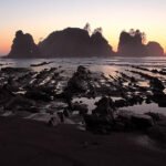 Panda Cake A serene sunset over the iconic sea stacks at Cannon Beach, Oregon, casting a warm glow across the Pacific Ocean and rocky shoreline.