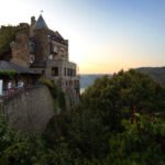 St. Goar & Bacharach A beautiful sunset view from the terrace of Castello di Amorosa, surrounded by lush greenery.