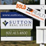 Drops A 'Sold' sign displayed on a real estate property featuring the Sutton Real Estate branding and contact information.