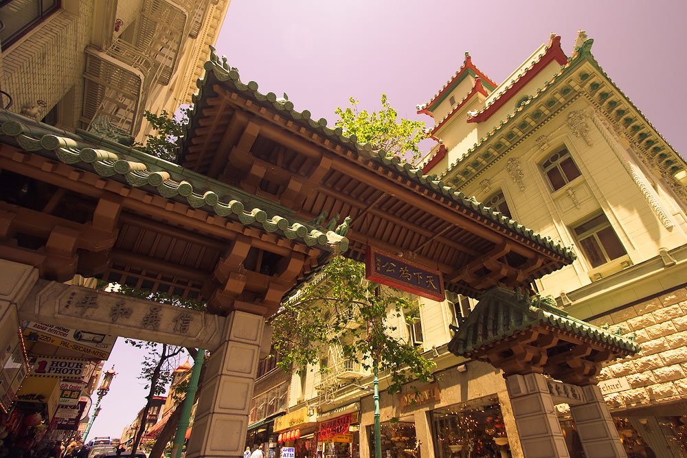 A serene image of traditional East Asian architecture, featuring ornate green-tiled roofs and intricate stone carvings.