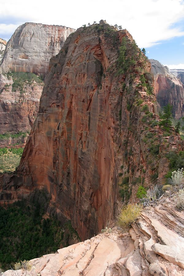 A stunning view of towering red rock formations with greenery.