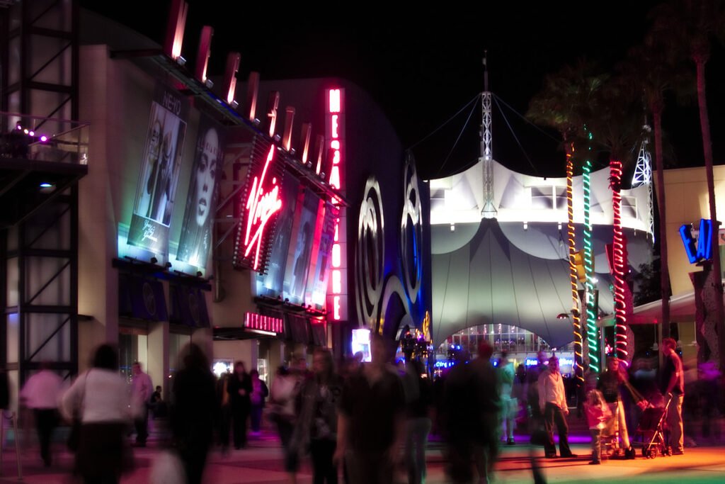 A bustling night festival with colorful lights and decorations. People are gathered, enjoying the lively ambiance.