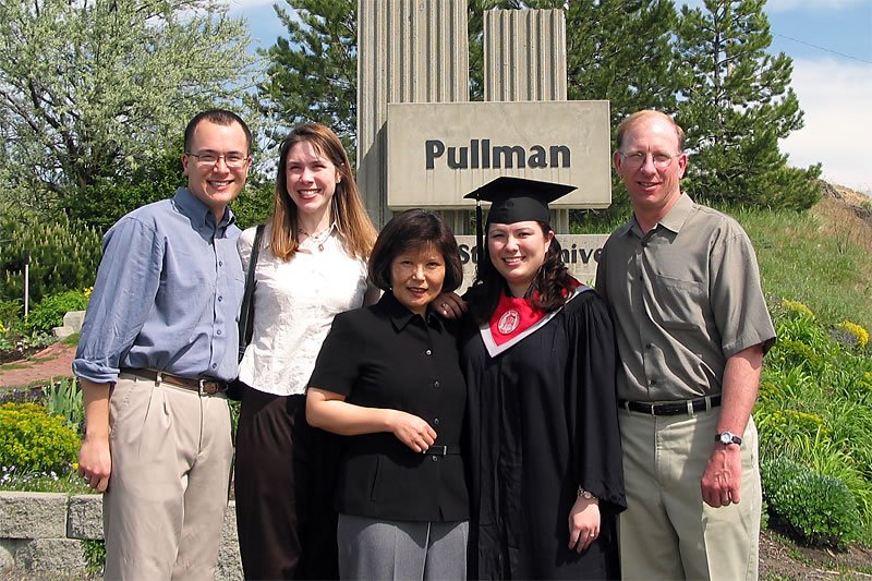 John, Kristie, and family celebrate a graduate at the Washington State University sign in Pullman, WA.