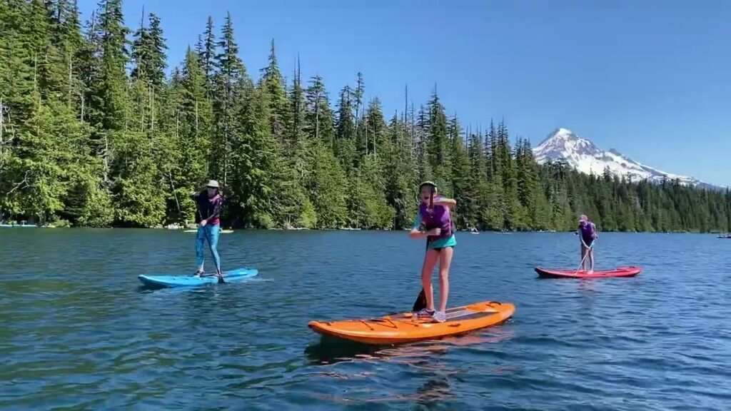 Paddleboarders on a lake with a mountain in the background.