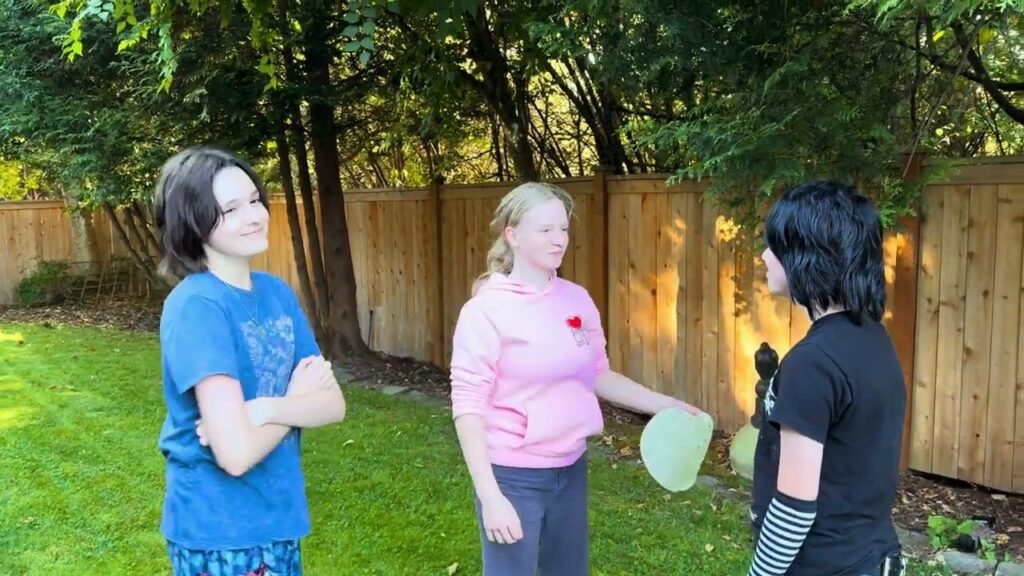 People enjoy an outdoor balloon game on a sunny day.