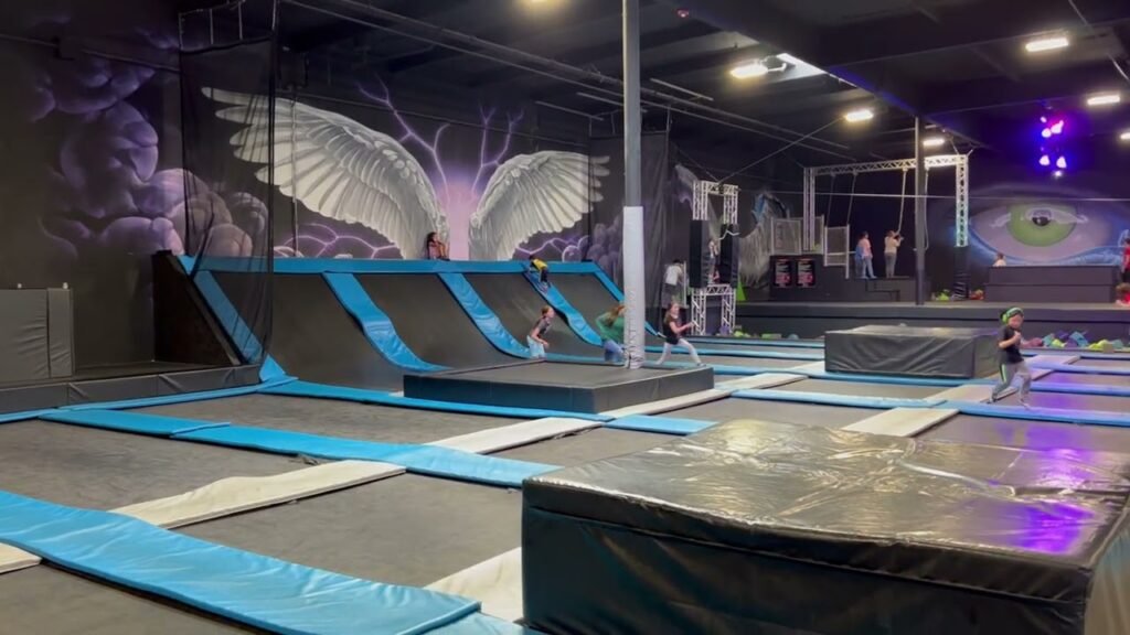Trampolines and trapeze equipment at Sky Zone Trampoline Park Seattle with branded wall graphics.