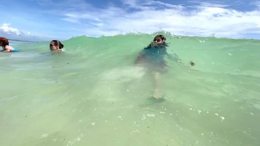 Swimmers enjoying the clear turquoise water during a swimming session.
