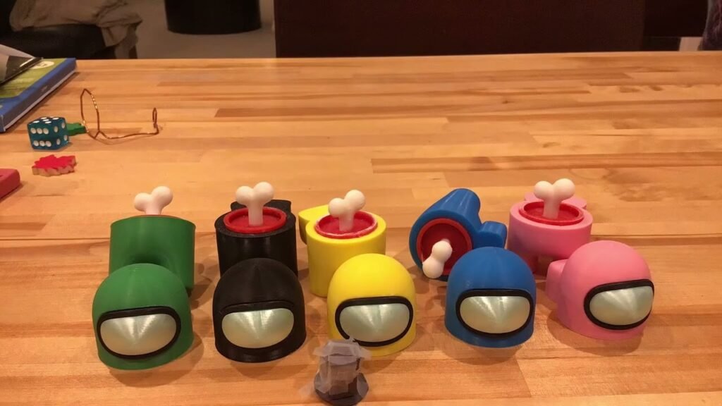 A collection of colorful Among Us plushies arranged on a wooden table.