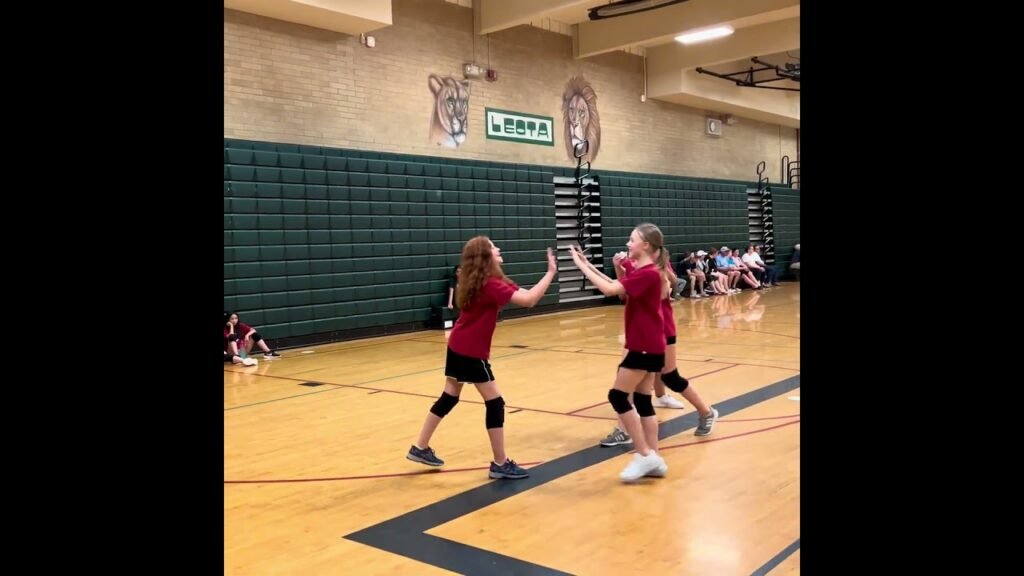 A dynamic sequence showing young volleyball players in red jerseys at a high school gymnasium.