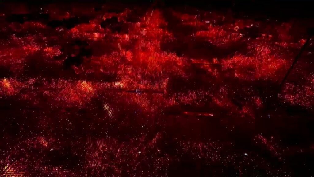 Abstract macro view of glowing red particles and clusters on a dark textured surface.