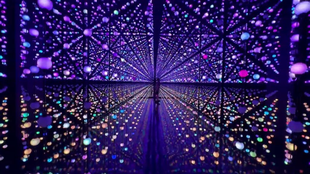 An abstract digital artwork featuring a receding star-shaped grid pattern filled with colorful, glowing dots against a dark purple background.
