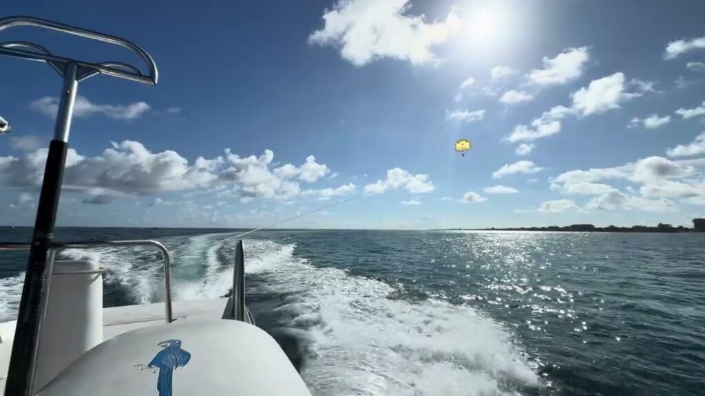 A person riding a boat on a sunny day, with the sun shining in the sky