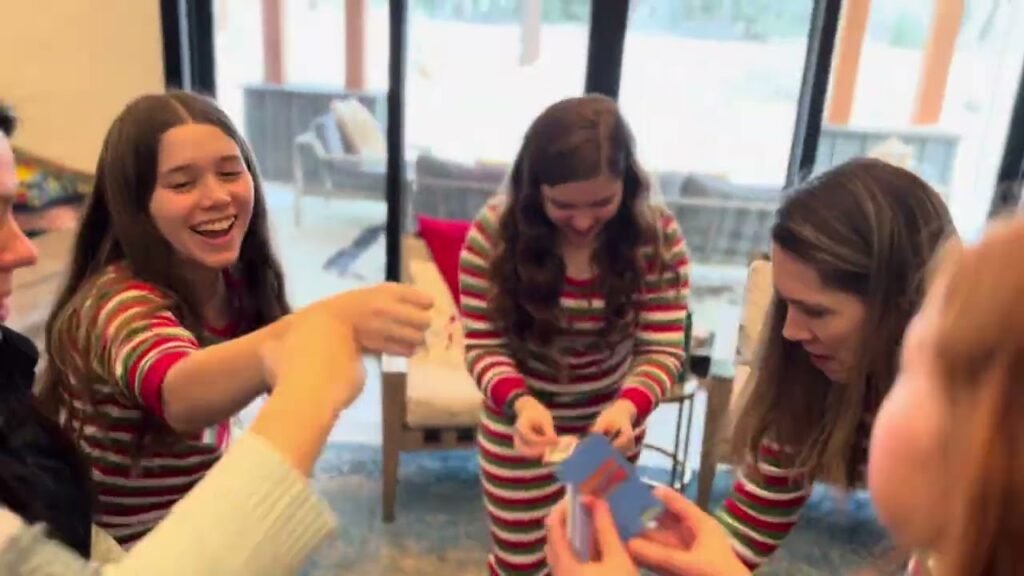 Family members enjoy a lively card game session, laughing and engaging with one another.