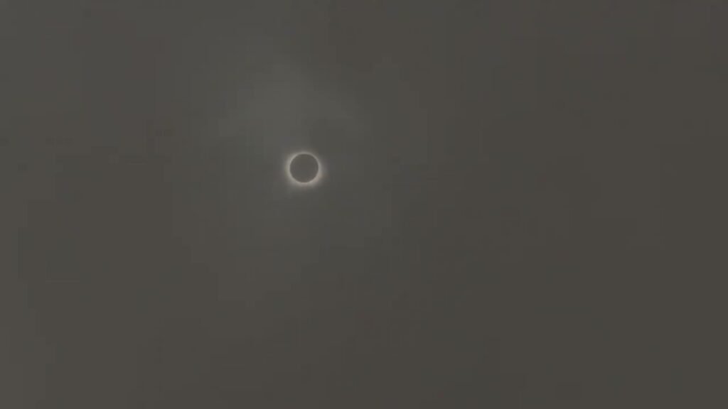 A side-by-side comparison of two photographs featuring a small, bright ring of the solar eclipse against a dark sky.