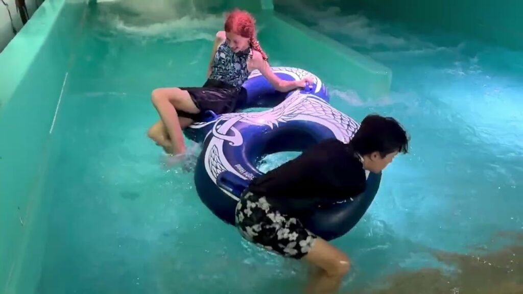 People enjoying a lazy river float at a water park in the Pacific Northwest, holding patterned tubes.